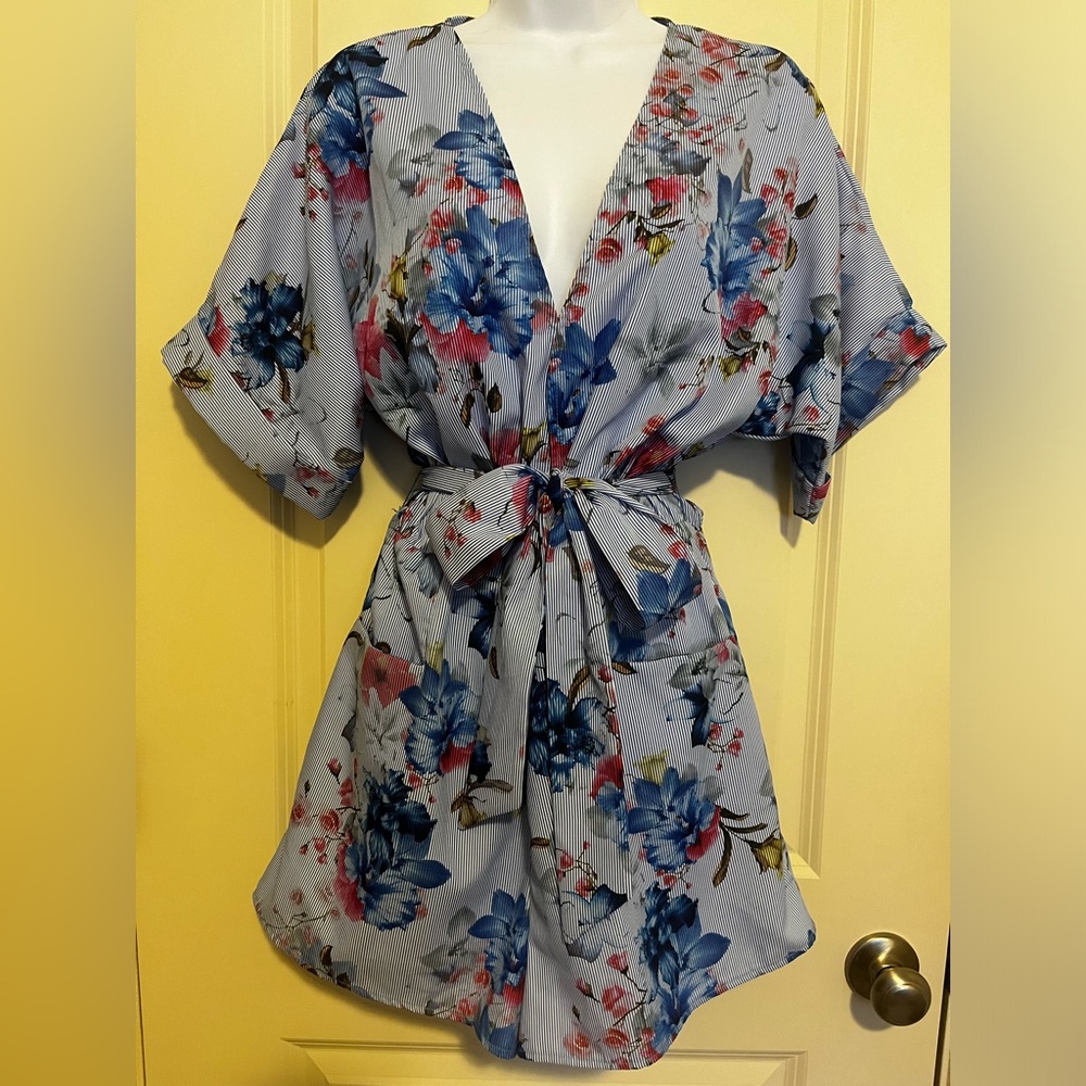 Blue striped and floral romper with buttons and tie front.